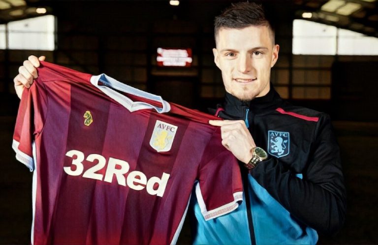 Frederick Gilbert holds up Aston Villa shirt