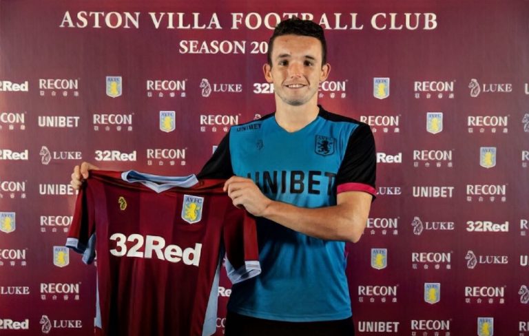 John McGinn signs for Aston Villa and holds up shirt
